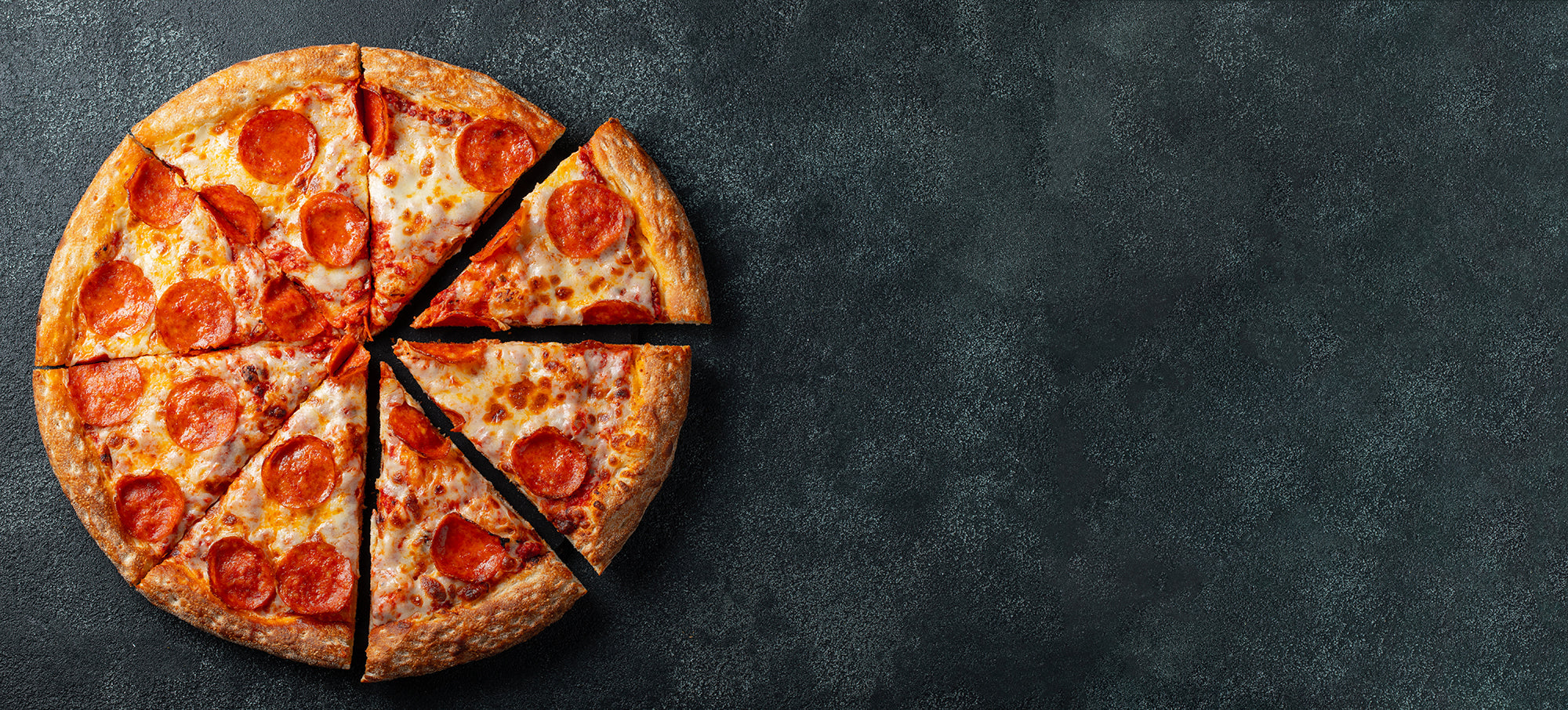 Delicious looking pepperoni pizza on a dark background